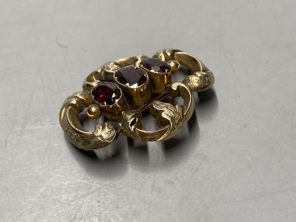 Two gold plated overlaid and gem set fob seals, largest 35mm, a 9ct front and back locket and a scroll brooch.